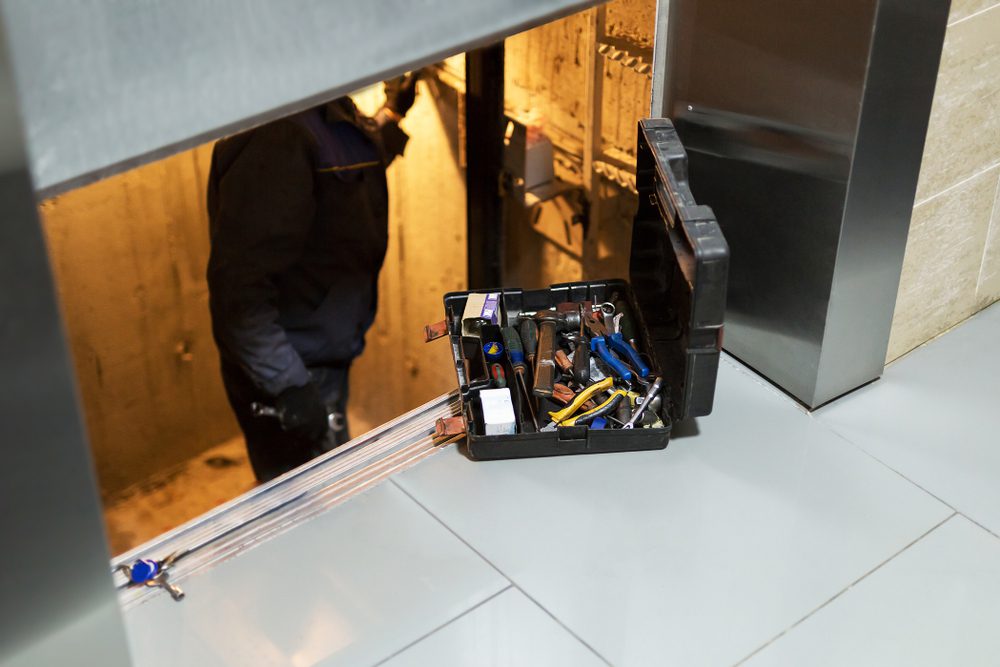 technician repairing a MRL lift